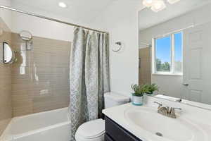 Bathroom featuring vanity and shower / bath combo with shower curtain