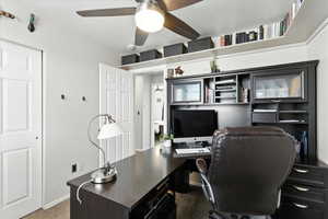 Office space with a ceiling fan and baseboards