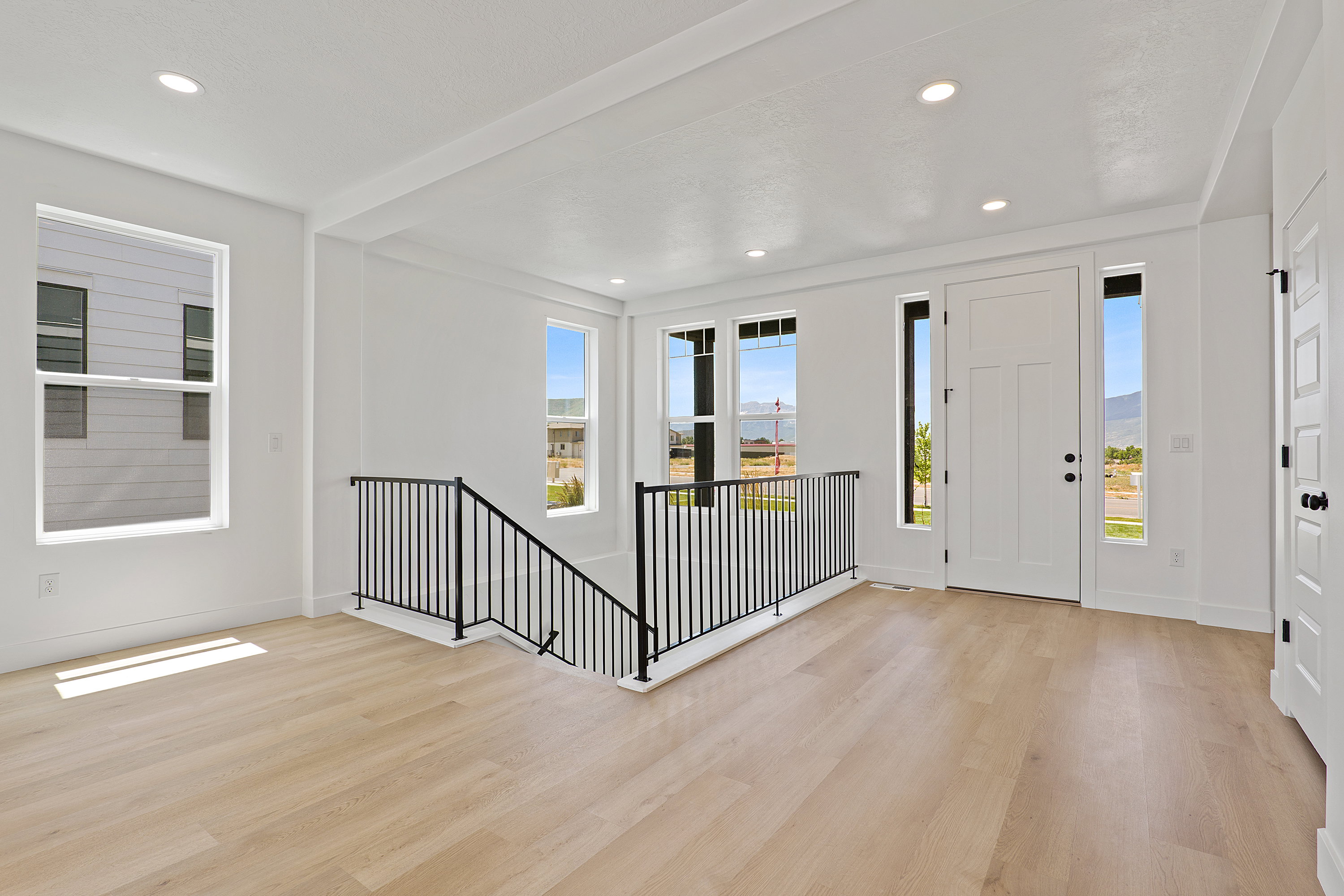 Foyer with light wood-style floors, plenty of natural light, and recessed lighting