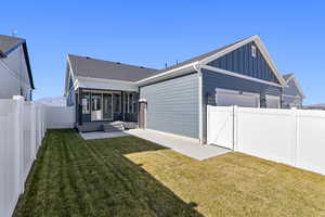 Back of house featuring a fenced backyard, a gate, board and batten siding, a patio, and roof with shingles