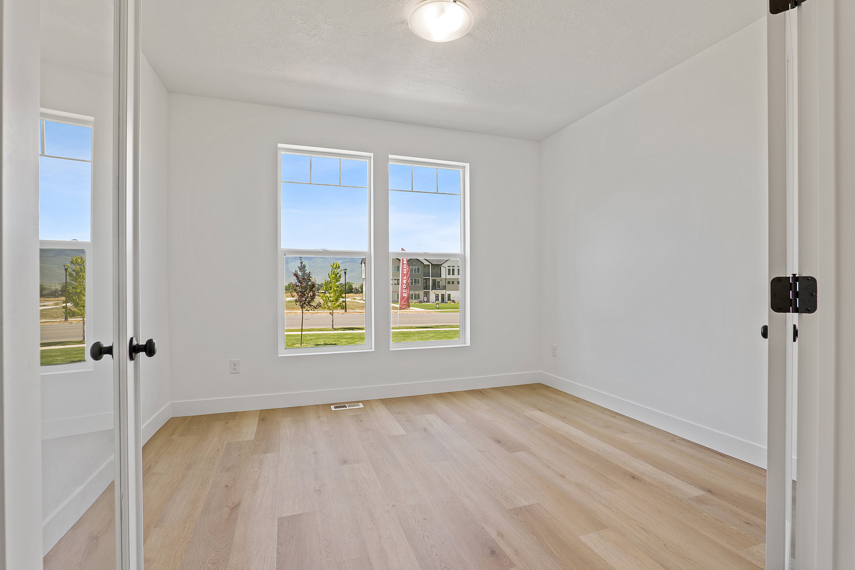 Unfurnished room featuring light wood-style flooring and baseboards