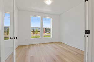 Unfurnished room featuring light wood-style flooring and baseboards