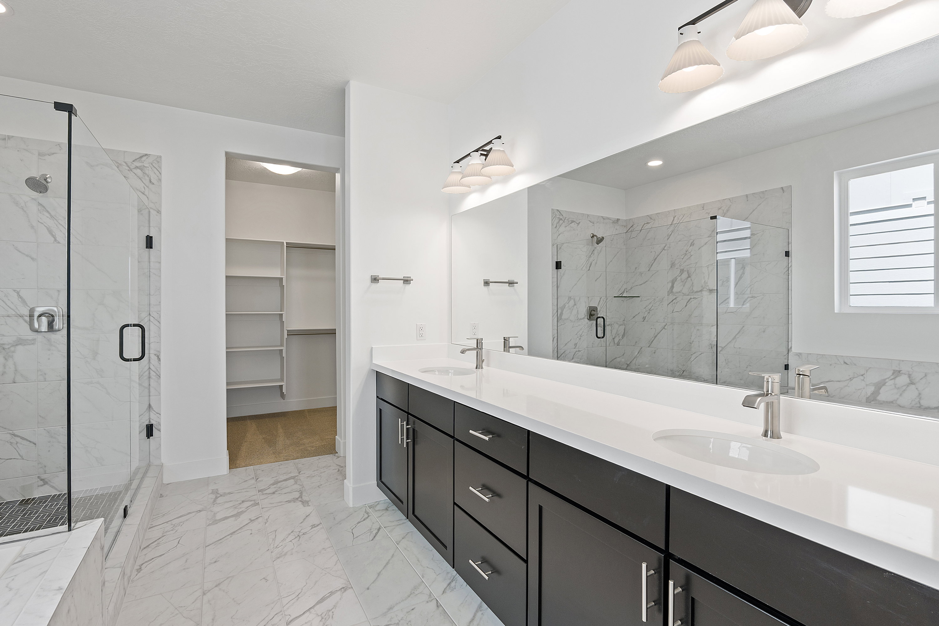 Full bathroom featuring marble finish flooring, a marble finish shower, double vanity, a walk in closet, and recessed lighting