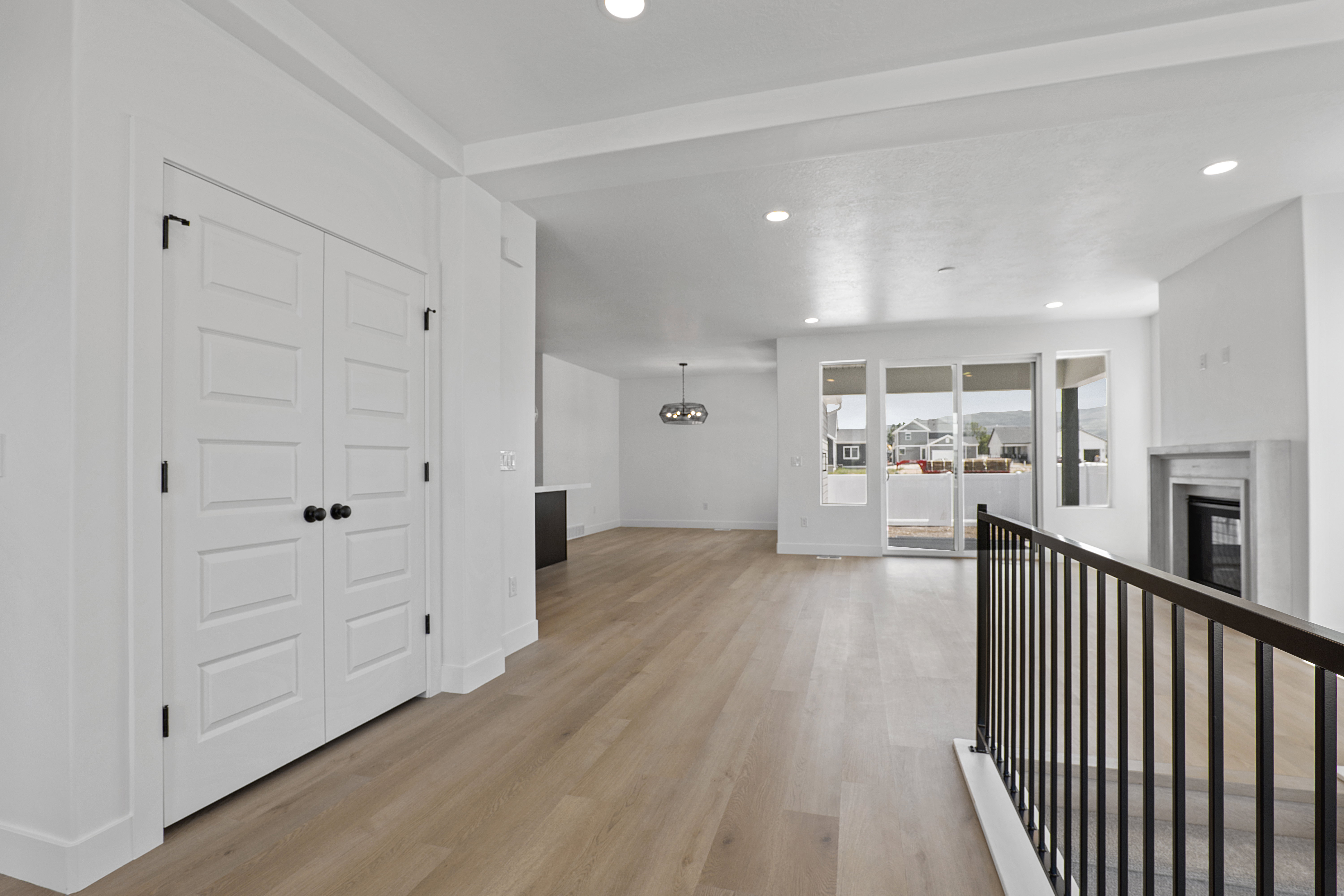 Corridor featuring light wood finished floors, recessed lighting, and a chandelier