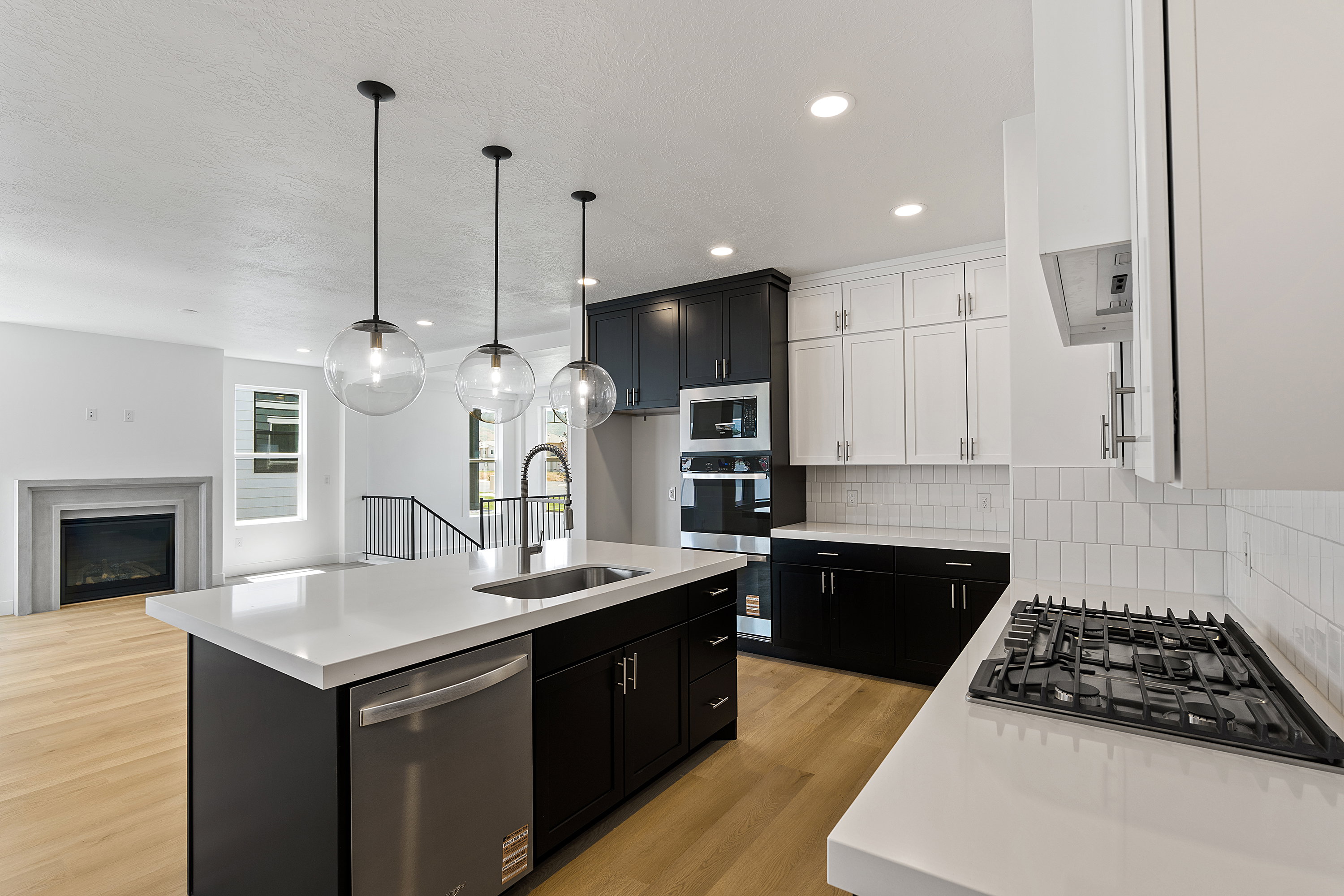 Kitchen with dark cabinets, backsplash, appliances with stainless steel finishes, light countertops, and recessed lighting