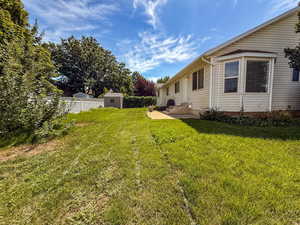 View of yard featuring a storage shed and a patio area