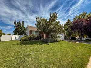 View of property exterior featuring an attached garage and driveway