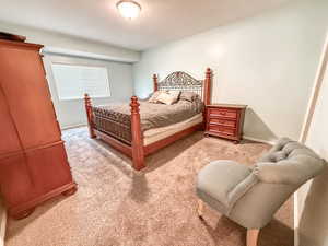 Carpeted bedroom with baseboards