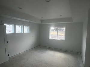 Spare room featuring a raised ceiling and recessed lighting