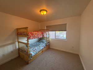 Carpeted bedroom featuring bunk beds.  Great mtn views