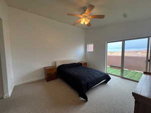 Carpeted bedroom featuring access to exterior deck and a ceiling fan