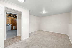 Carpeted spare room with baseboards
