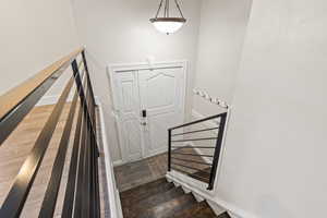 Stairway featuring wood finished floors and baseboards