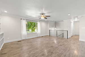 Empty room featuring crown molding, recessed lighting, light wood-type flooring, and ceiling fan