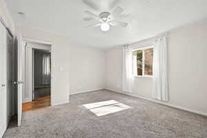 Unfurnished bedroom with carpet floors and ceiling fan