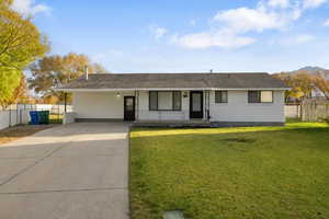 Ranch-style house with a porch, brick siding, roof with shingles, and concrete driveway