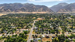 Aerial view of property's location featuring nearby area and mountains.