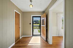 Entryway featuring wood flooring.