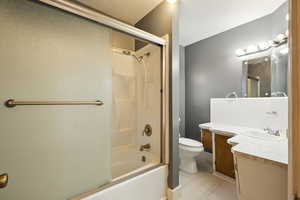 Main level bathroom featuring vanity, bathtub/ shower combination, and tile flooring.