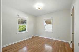 Main level bedroom with hardwood flooring.