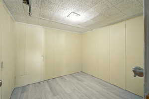 Empty room with light wood-type vinyl flooring.