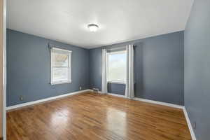Main level bedroom with hardwood flooring.