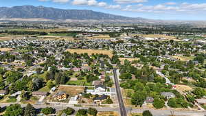 Aerial view of property's location featuring nearby suburban area and mountain background.