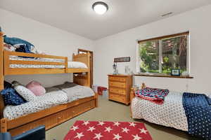 Bedroom with light colored carpet