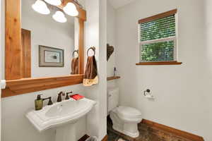 Half bath with a chandelier and tile patterned flooring