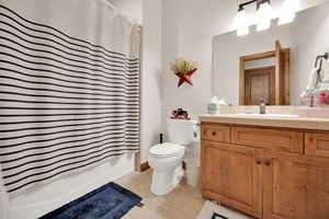 Full bathroom with vanity, tile patterned flooring, and shower / tub combo