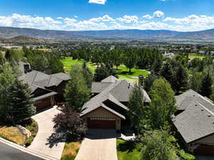 Aerial view of property and surrounding area featuring mountains