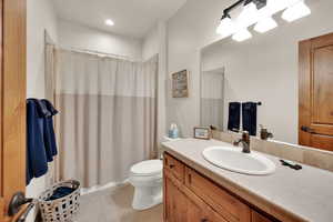 Full bathroom with vanity, tile patterned flooring, and a shower with shower curtain