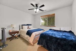 Bedroom featuring light carpet and a ceiling fan
