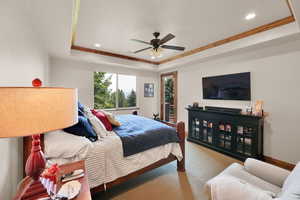 Carpeted bedroom with crown molding, a tray ceiling, recessed lighting, ceiling fan, and access to outside