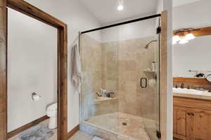 Bathroom featuring a shower stall and vanity