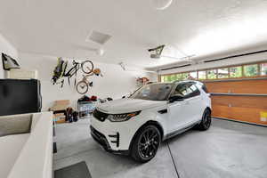 Garage featuring freestanding refrigerator