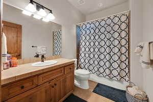 Full bath with vanity, tile patterned flooring, and shower / bath combination with curtain