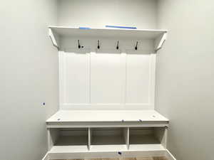 Mudroom with baseboards and wood finished floors