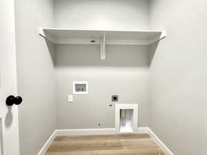 Laundry room with hookup for an electric dryer, light wood-style floors, washer hookup, and hookup for a gas dryer