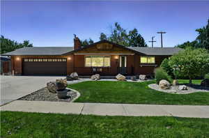 Front of the home with a large 2-car garage, and a cute front porch to decorate