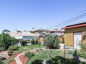 View of yard with a vegetable garden and a residential view