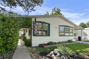 View of side of home with a yard