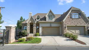 View of front of property with a garage, concrete driveway, a chimney, and roof with shingles