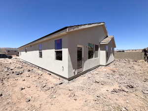 Rear view of house with stucco siding