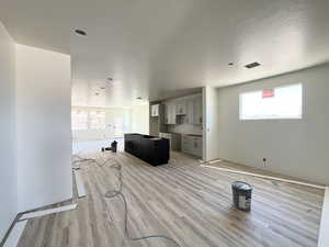 Kitchen with light wood-style flooring and a textured ceiling