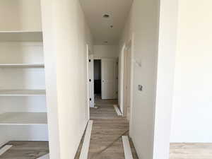 Corridor featuring light wood finished floors