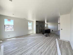 Unfurnished living room with light wood-style floors