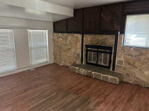 Unfurnished living room with a fireplace and wood finished floors