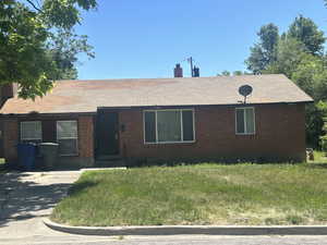 Single story home with brick siding and a chimney