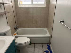 Full bath with tile patterned floors, vanity, and  shower combination